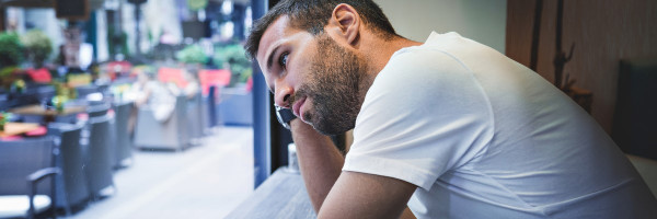 A man staring out a window