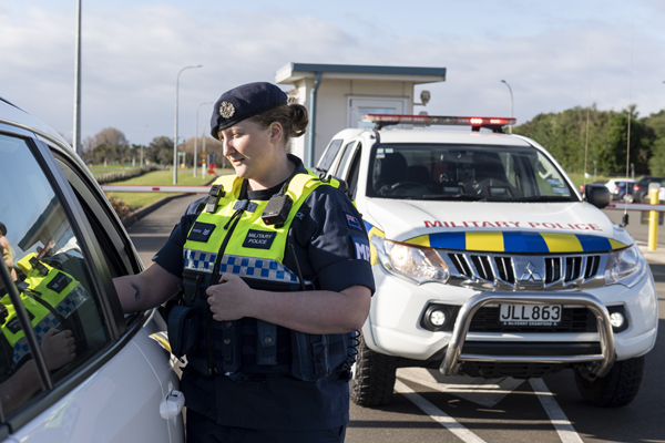 Military Police stopping a vehicle at a checkpoint